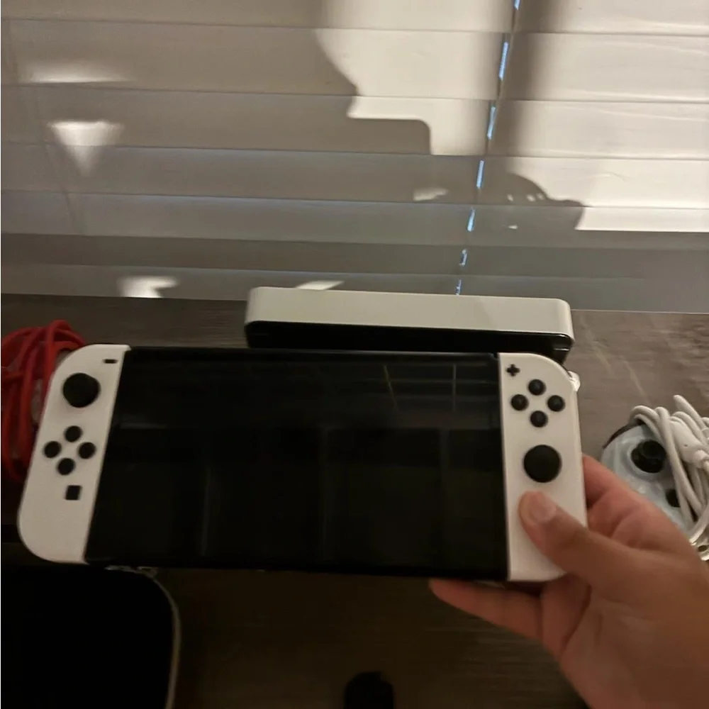 Nintendo Console with White and Black Controllers
